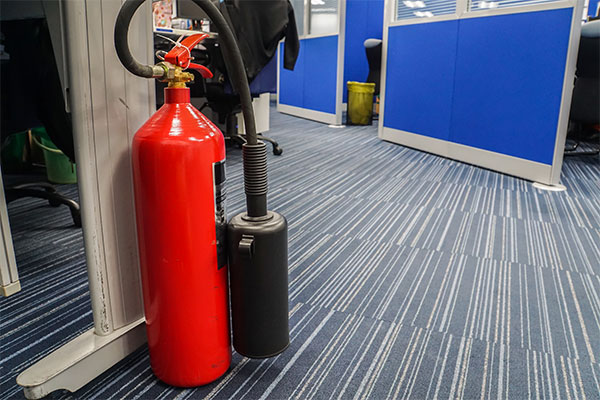 Red Fire Extinguisher in Office