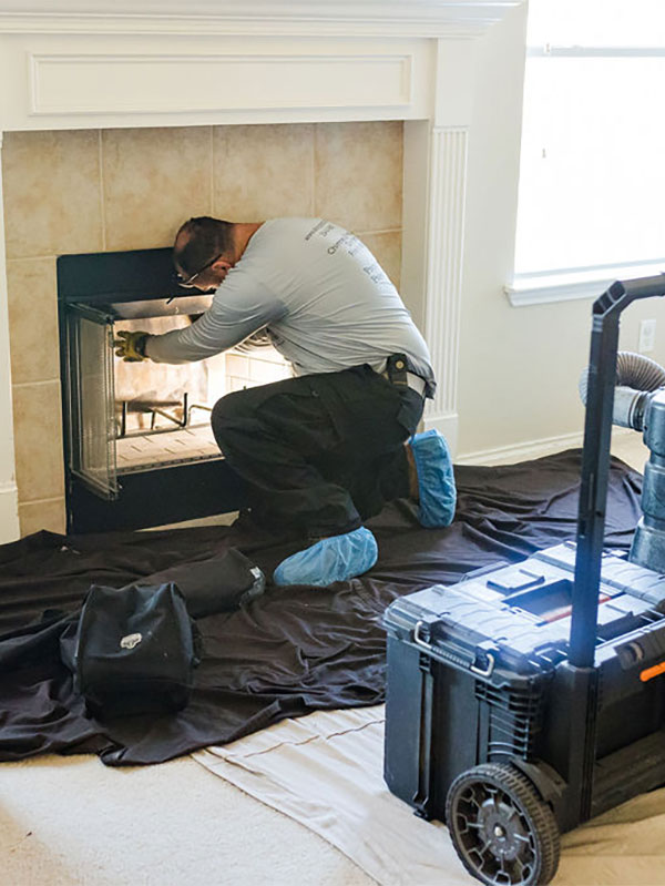 Technician Cleaning Fireplace Technician Cleaning Fireplace