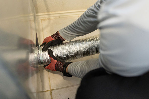 Technician Fitting a Dryer Vent