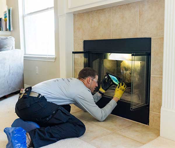 Technician Inspecting Fireplace