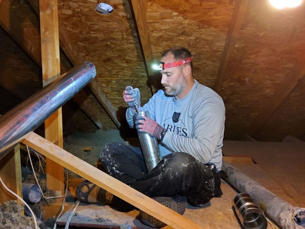 technician working on venting in attic technician working on venting in attic
